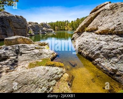 Couple in canoe in Sylvan Lake in Custer State Park in the Black Hills of South Dakota USA Stock Photo
