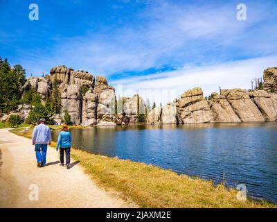 People on trail around Sylvan Lake in Custer State Park in the Black Hills of South Dakota USA Stock Photo
