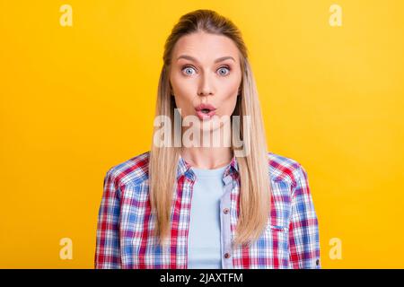 Photo of impressed blond young lady wear blue shirt isolated on yellow color background Stock Photo