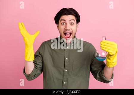 Photo of crazy amazed scientist guy hold flask open mouth wear gloves khaki shirt isolated pink color background Stock Photo