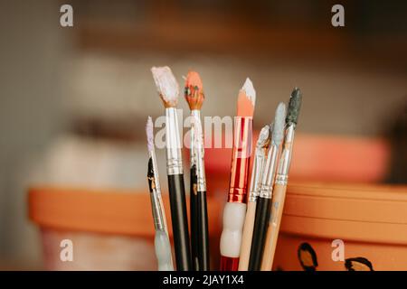 Brushes for painting. Terracotta pots in the background. Stock Photo