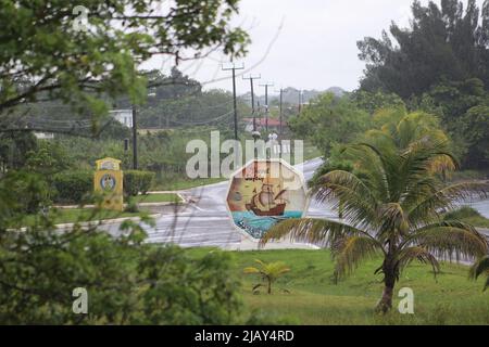 PUNTA GORDA, BELIZE - SEPTEMBER 11, 2016 Welcome to Punta Gorda Dollar Sign at the junction of the only road out of town in the rain Stock Photo