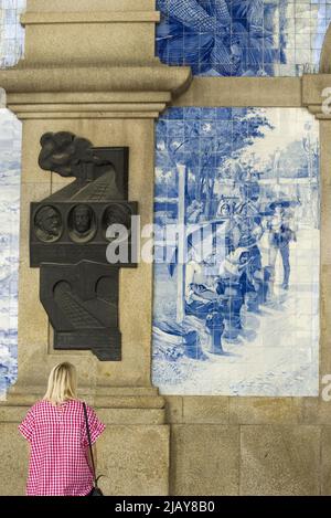 Decorative ceramic tiles azulejos surround the interior of the entrance hall of the railway station in Porto Stock Photo