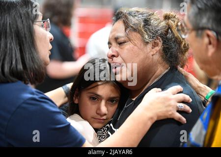 Uvalde Texas USA, May 25 2022: A fourth-grade teacher from Robb Elementary School hugs a student during a community-wide service of healing after a lone gunman entered Robb Elementary School the day before and killed 21 people, including 19 children. The woman wished not to be identified. ©Bob Daemmrich Stock Photo
