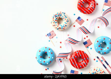 Flat lay doughnuts in colors of American flag and decorations isolated on white background. Happy Independence Day, Labor day, Presidents Day in US co Stock Photo