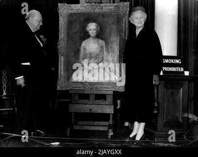 Present From Woodford: Sir Winston and Lady Churchill admire the birthday gift painting which is by John Napper. The Prime Minister, Sir Winston Churchill, was presented with a portrait of Lady Churchill this evening, as a birthday gift from his constituency at Woodford. The presentation was made at the girls' county high school, Woodford. November 23, 1954. (Photo by Paul Popper, Paul Popper Ltd.) Stock Photo