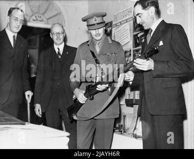 Duke Inspects Youth Exhibition -- The Duke looking at a model rifle made by boys of the boys Cluds Association. The Duke of Gloucester visits 'The Spotlight on Youth Exhibition' at Harrods. An exhibition of youth movement activities. July 26, 1943. (Photo by L.N.A.) Stock Photo