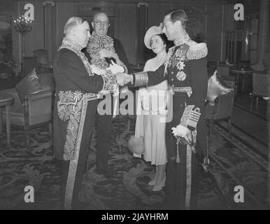 Royal Canadian Tour: Scenes On -- Board the Empress of Australia. Our photograph shows the King being greeted by Mr. MacKenzie King on board the Empress of Australia on Their Majesties arrival in Canada. June 13, 1939. Stock Photo