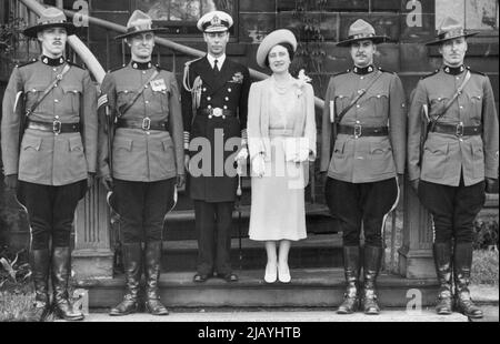 The Royal Farewell To Canada -- Our photograph shows the King and Queen with the four Canadian Mounted Police who were their personal body-guard during the Canadian tour. July 11, 1939. Stock Photo