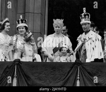 King George VI, wearing the Imperial State Crown, on the balcony of Buckingham Palace after the Coronation where he acknowledged the cheers from the vast crowds that had gathered to acclaim the newly-crowned Sovereign. With him are Queen Elizabeth, Queen Mary, Princess Elizabeth and Princess Margaret. The Princesses are wearing their coronets which they put on with the Peeresses, after the crowning of the Queen. June 3, 1953. Stock Photo