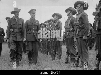 The King Inspects Australians 'Somewhere in England': The King inspecting a unit of the Australian troops now in this country when he paid a visit to them at their headquarters 'Somewhere in England'. One of the King's proudest moments was when he inspected Australian troops in England, later to leave for the Middle East. 'They are a fine body of men.' was his typical comment. February 7, 1952. (Photo by Associated Press Photo). Stock Photo