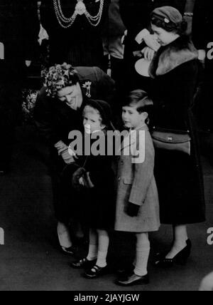 Family Reunion -- This happy picture was taken today at Waterloo Station. The Queen Mother had just arrived after her tour of America and Canada. The Queen watches as the Queen Mother stoops to talk to Princess Anne. Young Prince Charles completes the happy group. November 24, 1954. (Photo by London Express News And Feature Service). Stock Photo