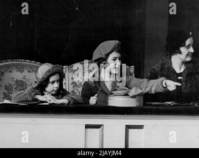 Princess Elizabeth And Sisters At Pony Show -- Princess Elizabeth (right) points out and incident in the judging ring to her sister, Princess Margaret Princess Elizabeth and Princess Margaret Rose this afternoon visited the National Pony Show at the Agricultural Hall, Islington. March 4, 1938. (Photo by Keystone). Stock Photo