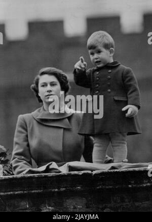 Queen Juliana Visits The City And Prince Charles Watches : Warmly wrapped little Prince Charles and Princess Elizabeth watch the procession from the wall of Clarence House today. The Princess double wrapped her green coat collar against the cold wind. Queen Juliana and the Prince of the Netherlands today drove in state to the Guildhall for luncheon with the Lord Mayor of London and the Corporation. Like any other little boy, Charles points excitedly as Queen Juliana of the Netherlands drives past his gate. November 22, 1950. (Photo by Fox Photos). Stock Photo