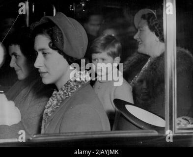 Back To Meet Mother : Prince Charles, returning from Sandringham to meet his mother on her return today, Feb. 12, from Malta, is pictured here with the Queen and Princess Margaret as he leaves King's Cross Station en route to Buckingham Palace and Clarence House. With them returned the King and Princess Anne. February 21, 1951. (Photo by Associated Press Photo). Stock Photo
