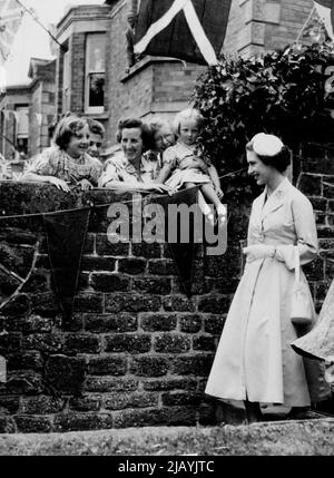 It was all so... will, neighbourly. There was Princess Margaret, just over the garden wall. And how She smiled as she passed by. These people at Bridport (Dorset) were among the thousands who cheered the Princess during her visit to the town yesterday. It was a special treat for the children - particularly those who, like these two, had a close-up view. June 25, 1953. (Photo by Daily Mirror). Stock Photo