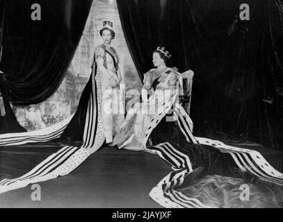 In The Throne Room Of Buckingham Palace -- Queen Elizabeth the Queen Mother and Princess Margaret wearing their coronation robes are seen in the Throne Room of Buckingham Palace, London, on Coronation day June 2nd, 1953. The Queen Mother's gown is of creamy white satin, short sleeved with a U-shaped inset of gold lame on the bodice. It is embroidered in a delicate design, worked horizontally, of trailing ostrich feathers, the stems of glittering diamante. Princess Margaret's dress was the only all-white one worn by the Royal party in the Abbey. Sleeves and bodice are embroidered with silver, d Stock Photo