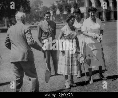 Spade Work for The Princess -- Touring Princess Margaret, second from right, waits to be handed a spade before planting a tree in king's House Gardens, Kingston, Jamaica, in an informal ceremony Feb.21. At right is Lady Foot, wife of Jamaica's Gov. Sir Hugh Foot. Others are not identified. February 22, 1955. (Photo by Associated Press Photo). Stock Photo