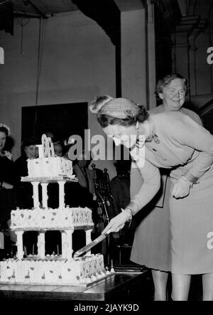 Duchess Attends 80th Birthday Of Croydon School -- Her Royal Highness The Duchess of Gloucester seen cutting the magnificent Birthday cake bearing 80 candles on the platform in the school hall at the Croydon high school for girls today - it's 80th. Birthday. Behind the Duchess can be seen Miss M.F. Adams, the Head Mistress. H.R.H. The Duchess of Gloucester today attended the 80th. Birthday Celebrations of the Croydon High School for Girls. Throughout her visit the Duchess was entertained by the various activities of the pupils at the School, in Which she showed great interest. May 20, 1954. (P Stock Photo
