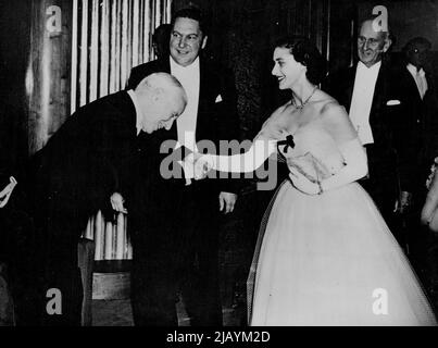Charlie Welcomes Princess To Premier -- Charles Chaplin Deams as he bends over the hand of Princess Margaret as the Princess arrived at the Odeon theatre, Leicester-Square, London, this evening, October 16, for the premiere of Chaplin's new film 'Limelight', Others in picture are unidentified. October 16, 1952. (Photo by Rota Picture). Stock Photo