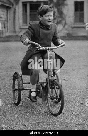 Royal Pages - Prince Michael of Kent, with the superb disregard of five years for the heavy responsibilities ahead of him, ***** enjoys himself on his tricycle at his home at Iver, Bucks. Prince Michael of Kent will be one of the pages attending his cousin, Princess Elizabeth at her wedding on the 20th November. 2.11.47. November 18, 1947. Stock Photo