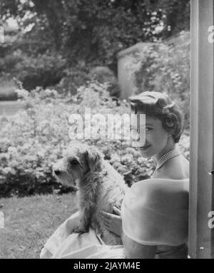 Princess Margaret - A new picture of Princess Margaret who is 25 on August 21. It was taken July 19 by Cecil Beaton in the garden of Clarence house. The Princess, who is with her Sealyham Pippin, wears a pale yellow dress of paper Shantung Taffeta with a collar of white organza, a five-string pearl necklace and a rose diamond brooch. August 21, 1955. (Photo by Cecil Beaton, The Associated Press Ltd.). Stock Photo