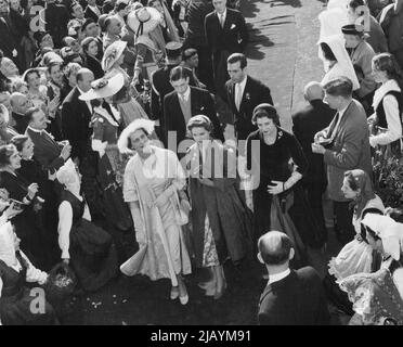 Costumed girls curtsy as The Duchess of Kent (Left, in Furry Hat) enters the church with her daughter, Princess Alexandra (right) and son, the 19-year-old Duke of Kent (behind Duchess). They represented Queen Elizabeth II. February 25, 1955. (Photo by United Press) Stock Photo