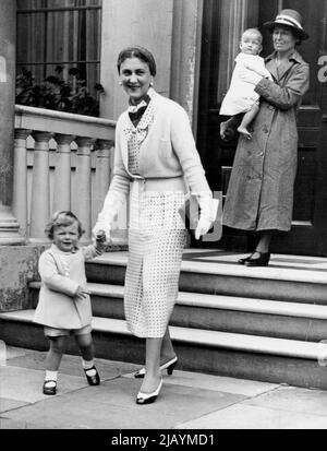 Royal Children Leave For Holiday -- The Duchess of Kent holding Prince Edward's arm, being followed by her baby daughter, Princess Alexandra, leaving Belgrave Square, London, this afternoon. The Duchess of Kent, accompanied by her children, left London this afternoon for a holiday at Sandwich. July 26, 1937. (Photo by Topical Press). Stock Photo