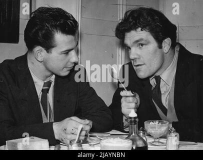 There's nothing like a tip or two from a man who knows all the answers. And here's Terry Ratcliffe, the clever young Brastol welterweight, getting some sound advice over the lunch table on how to become a champion from Freddie Mills, that great-heared ring character who brought the world lightheavy-weight title to Britain. Freddie still keeps his first in by sparring in the gym, and Terry is among the partners who benefit. February 06, 1951. (Photo by Daily Mirror). Stock Photo