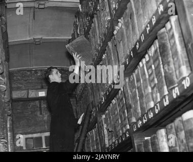 Ledgers Of Two And A Half Centuries: A view of the archives of ledgers dating back until 1673. Thick dust covers the heavy leather-bound books which contain many interesting details about famous peoples' finances in centuries part. December 10, 1938. Stock Photo