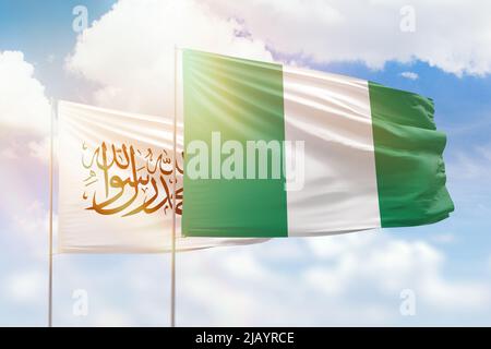 Sunny blue sky and flags of nigeria and afghanistan Stock Photo