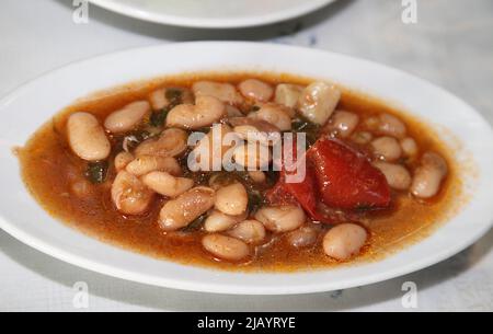 Traditional Turkish food 'Haricot Bean' (Turkish: Kurufasülye) on the dinner plate. Stock Photo