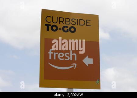 Curbside To-Go directional sign is seen in the parking lot outside an Amazon Fresh grocery store in Irvine, California, on Sunday, May 8, 2022. Stock Photo