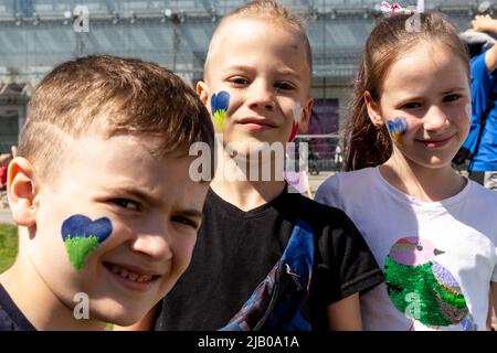 Ukrainian refugee children seen with Ukrainian and Polish national colours painted on their chicks during the Children's Day at Jezioranski Square. The outdoor games are organised in both Polish and Ukrainian languages by PKP Intercity transport company. As more than 3.5 million people have fled Ukraine for Poland, the country looks for ways to integrate and accommodate newcomers. The Polish population welcomed the refugees, and many NGOs provide humanitarian help. Stock Photo