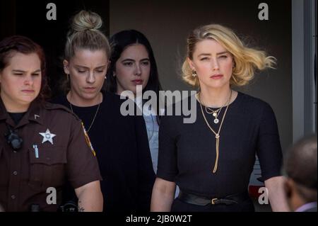 Actress Amber Heard, right, and her sister Whitney Heard, left, depart the Fairfax County Courthouse following the verdicts in her trial against Johnny Depp in Fairfax, VA, USA, Wednesday, June 1, 2022. Johnny Depp won a defamation suit Wednesday against his former wife Amber Heard after a jury found that she had defamed Depp in saying that he had abused her over the course of their relationship .Photo by Rod Lamkey/CNP/ABACAPRESS.COM Stock Photo