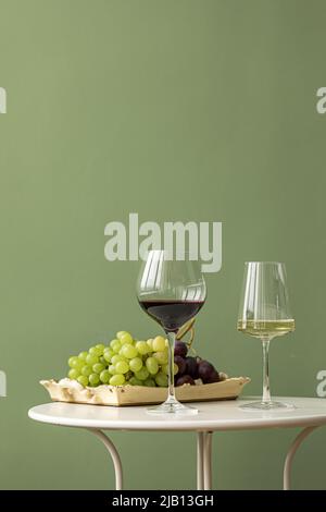 Glasses of white and red wine with grapes Stock Photo