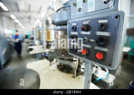 Close-up of control panel of clock movement machine with black and red buttons and small switch Stock Photo
