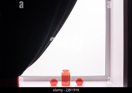 Three empty glass red vases on the windowsill.  Stock Photo