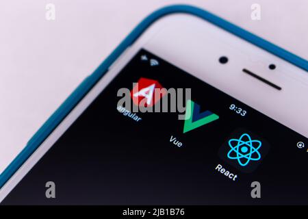 Kumamoto, JAPAN - Feb 15 2021 : Concept image three icons of modern JS libraries (Angular, Vue.js and React) on iPhone. Stock Photo