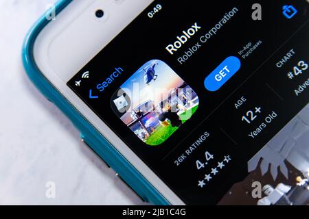 Roblox Logo and App on a Mobile Screen in a Hand Editorial Stock