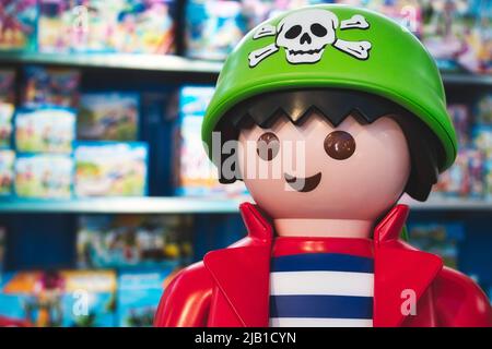 Giant Playmobil pirate figure in a toy shop with shelves of Playmobil box sets Stock Photo