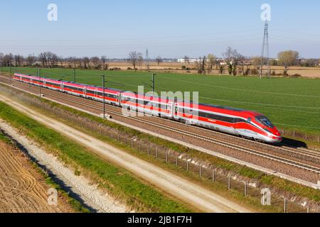 Melegnano, Italy - March 24, 2022: Frecciarossa FS ETR 1000 high-speed train of Trenitalia on the Milan - Bologna high speed rail railway line near Me