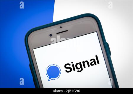The logo of Signal app on smartphone screen on Two Tone Color bg. Conceptual blue color in stylish mood. Popular tech app for messaging and video call Stock Photo
