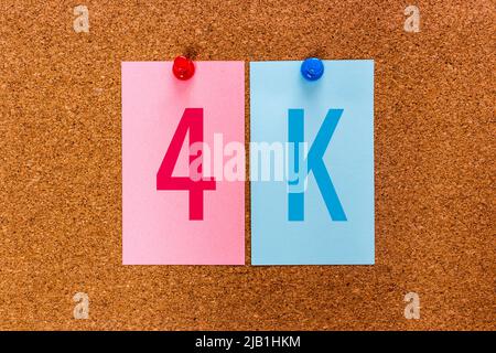 2 letters keyword 4K on multicolored stickers attached to a cork board. 4K resolution refers to a horizontal display resolution of approx. 4000 pixels Stock Photo