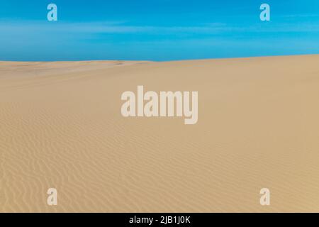 Ripple marks on Sand Dunes in Desert Area with blue sky. In geology, ripple marks are sedimentary structures and indicate agitation by water or wind Stock Photo