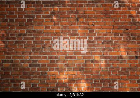 The wall of an old house made of red bricks. Can be used as background Stock Photo