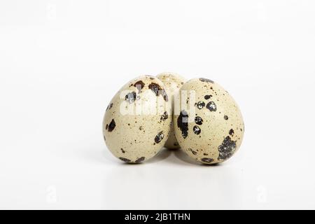 Set of three quail eggs isolated on white background with shadow Stock Photo