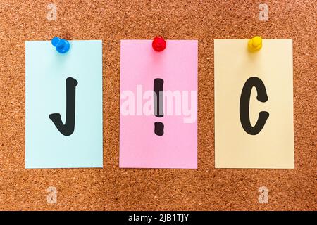Conceptual 3 letter acronym abbreviation JIC (Just In Case) on multicolored stickers attached to a cork board. Stock Photo