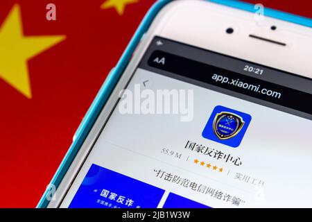 Kumamoto, JAPAN - Oct 25 2021 : Chinese anti-fraud app “National Anti-fraud Center” in Xiaomi’s App Store in iPhone on Chinese Flag. Stock Photo