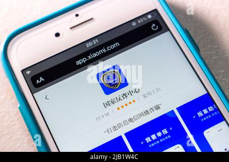 Kumamoto, JAPAN - Oct 25 2021 : Chinese anti-fraud app “National Anti-fraud Center” in Xiaomi’s App Store in iPhone on table Stock Photo